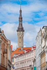 Obraz premium Old Town Tallinn Street with City Hall Tower and Red Roofs Background for Text