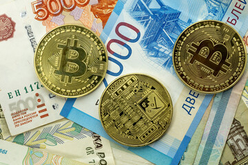 Russian currency of various denominations and a gold Bitcoin coin. Macro image of the Russian ruble. Profit growth. Stability concept.