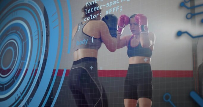 Sparring two women wearing sports bras and training gear at gym, with pink gloves, blue HUD