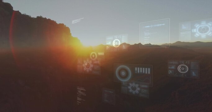Displaying canyon sunrise with floating HUD panels over valley, sun peeking left ridgeline, haze