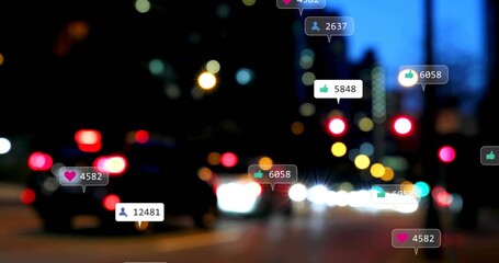 Showing blurry central roadway at dusk with cars, streetlights, traffic lights and reaction badges