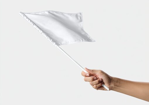 A hand holds a white flag on a white pole, blowing in the wind, against a light backdrop