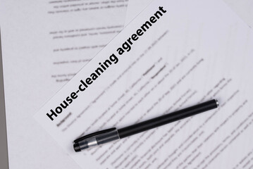 House cleaning agreement document on desk, legal contract for home maintenance and domestic service, symbol of responsibility, trust, and professional household care.