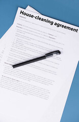 Obraz premium House cleaning agreement document on desk, legal contract for home maintenance and domestic service, symbol of responsibility, trust, and professional household care.