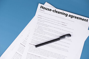 House cleaning agreement document on desk, legal contract for home maintenance and domestic service, symbol of responsibility, trust, and professional household care.