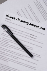 House cleaning agreement document on desk, legal contract for home maintenance and domestic service, symbol of responsibility, trust, and professional household care.