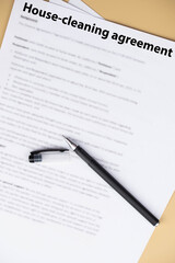 House cleaning agreement document on desk, legal contract for home maintenance and domestic service, symbol of responsibility, trust, and professional household care.
