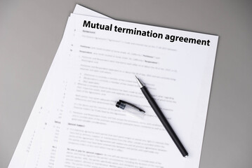 Mutual termination agreement document on office desk, professional legal contract ending business or employment relationship by consent, symbol of resolution, balance, and new opportunities.