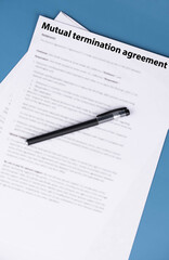 Obraz premium Mutual termination agreement document on office desk, professional legal contract ending business or employment relationship by consent, symbol of resolution, balance, and new opportunities.