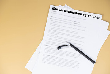 Obraz premium Mutual termination agreement document on office desk, professional legal contract ending business or employment relationship by consent, symbol of resolution, balance, and new opportunities.