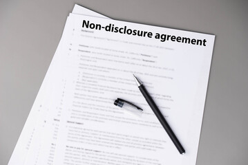 Non disclosure agreement (NDA) document on office desk, confidential legal contract for business privacy, data protection, and corporate trust concept.