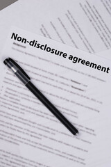 Non disclosure agreement (NDA) document on office desk, confidential legal contract for business privacy, data protection, and corporate trust concept.