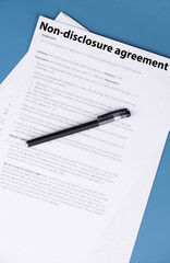 Obraz premium Non disclosure agreement (NDA) document on office desk, confidential legal contract for business privacy, data protection, and corporate trust concept.
