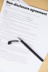 Non disclosure agreement (NDA) document on office desk, confidential legal contract for business privacy, data protection, and corporate trust concept.