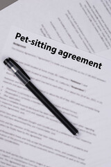Pet sitting agreement document on desk, legal contract for animal care during owner&rsquo;s absence, symbol of responsibility, trust, love, and professional pet services.