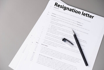Resignation letter on office desk, formal document where employee voluntarily leaves job, symbol of professional change, career transition, and emotional decision at workplace.