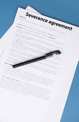 Obraz premium Severance agreement document on office desk, legal contract detailing terms of job termination and severance pay, symbol of closure, protection, and career transition in professional life.