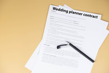 Obraz premium Wedding planner contract on desk, professional legal agreement for event coordination, vendor management and wedding organization, symbol of trust, creativity, and celebration planning success.
