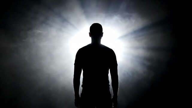 A cinematic, slow-motion shot of a person's silhouette from behind.