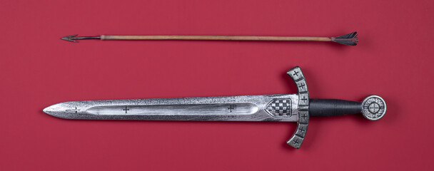 Templar sword isolated on red background