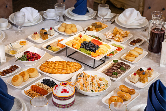 Kazakh national dastarkhan table with traditional decor and festive dishes