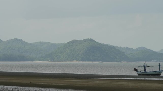 June 1, 2025 - Sam Rai Yod, Thailand: Small fishing boats are lining along the beach at the Sam Roi Yod Beach.