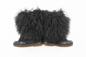 Black long fur boots isolated on white background