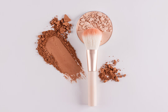 Makeup brush with face powder and compact detail