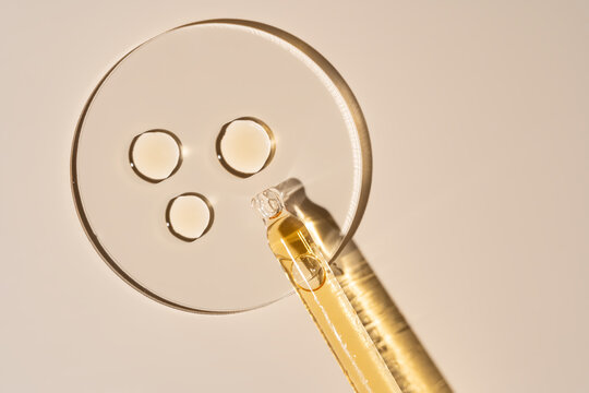 Cosmetic swatches with pipette on beige background