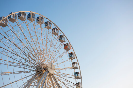 Ferris wheel against a clear blue sky on a sunny day