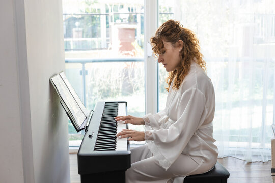 Woman enjoying leisure time with piano hobby