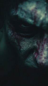 Terrifying zombie face emerging from darkness with a haunting eye staring forward. Cinematic Halloween horror scene with decayed skin, eerie shadows, and intense fear.