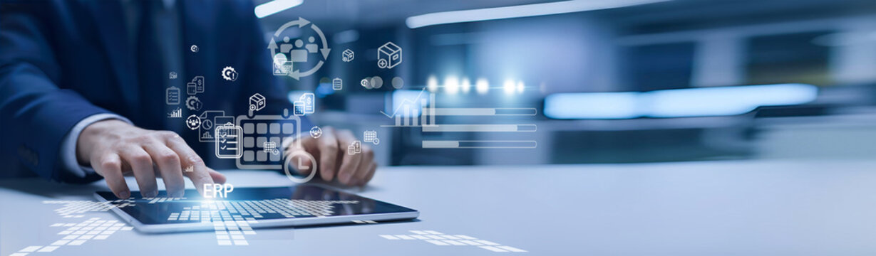 Business analyst holding ERP dashboard. ERP integrates finance, operations, HR, and supply chain into one centralized management system.