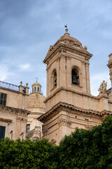 Obraz premium Sicilian cathedral bell tower with stone architecture and greenery