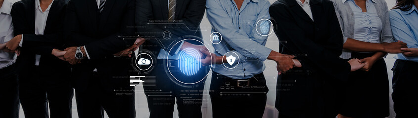 A diverse business team poses together with a digital overlay featuring fingerprint technology,...