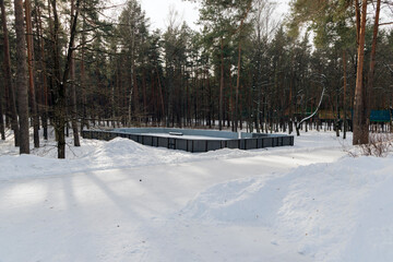Outdoor Skating Rink in Snowy Winter Forest Park