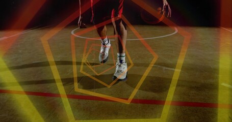 Dribbling player on gym court with ball by right hand, red shorts, shoes, painted arc, hexagons