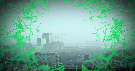 Framing midrise commercial buildings and cranes from roof, with elevated highway and green overlay