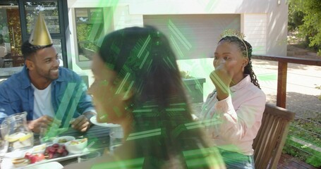 Sitting adults wearing denim shirt and light pink jacket in backyard, wearing party hat, tiara © vectorfusionart