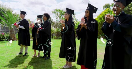 Clapping seven graduates in academic regalia on lawn, holding red diplomas and AR overlays
