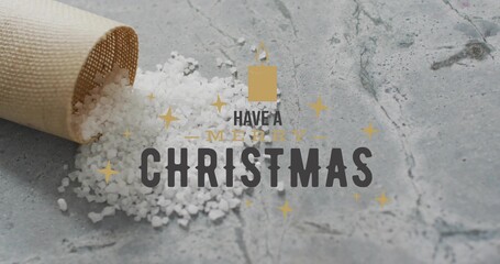 Fototapeta premium Spilling rolled beige cone spreading coarse white salt across gray stone surface, holiday greeting