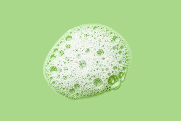 Cosmetic cleansing washing white soapy foam gel on apple green mint isolated background 