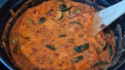 Recipe of vegetable stew with lentils in a pot on the stove