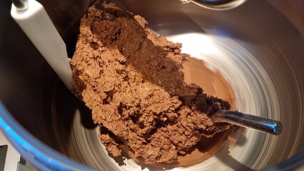 Mixing chocolate dough in a kitchen mixer for dessert preparation