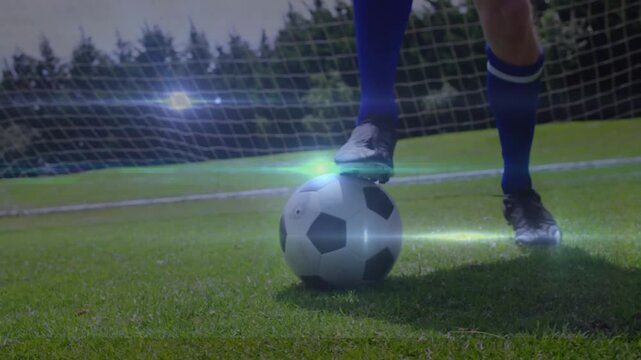 Animation of network of connections over legs of caucasian football player with football