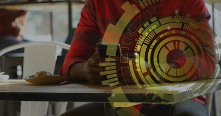 Holding smartphone, man in red shirt sitting at cafe table with pastry plate and HUD overlay
