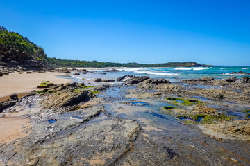 Exposed by low tide flat rock ledge at one end Chinamans Beach at Evens Head NSW Australia.