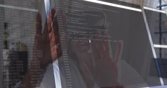 Senior woman wearing VR headset, reaching screen as terminal code overlays reflection for coding