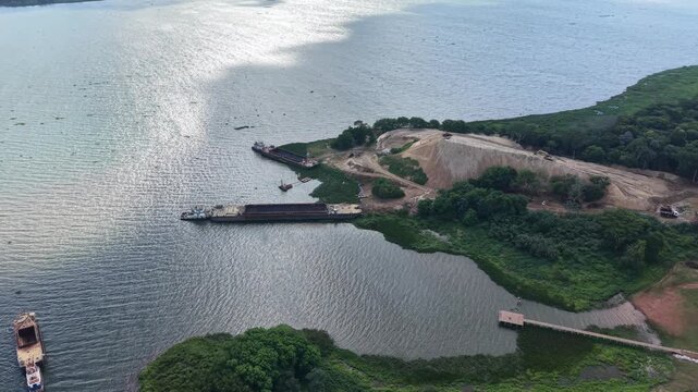Aerial video footage of a serene landscape with a body of water and lush greenery