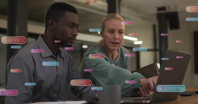Woman tapping laptop trackpad and using tablet, guiding man through business data with UI overlays
